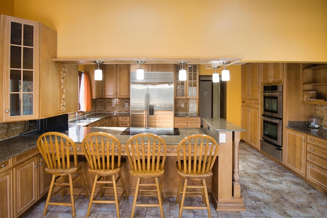 10773 Frankfort, Pinckney, MI 48169 - kitchen featuring appliances with stainless steel finishes, a breakfast bar area, pendant lighting, and backsplash