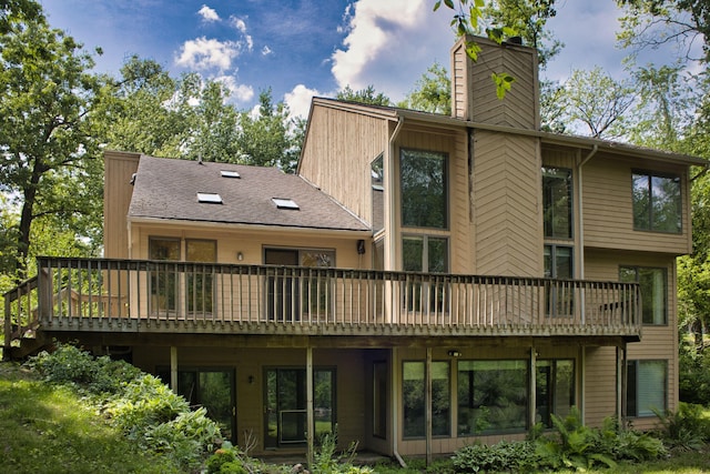 10773 Frankfort, Pinckney, MI 48169 - rear view of house featuring a wooden deck