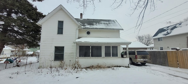 view of snow covered rear of property