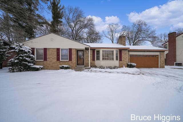 ranch-style house with brick siding, a chimney, an attached garage, and cooling unit