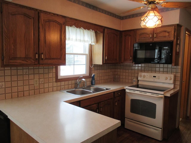 kitchen featuring sink, backsplash, and black appliances