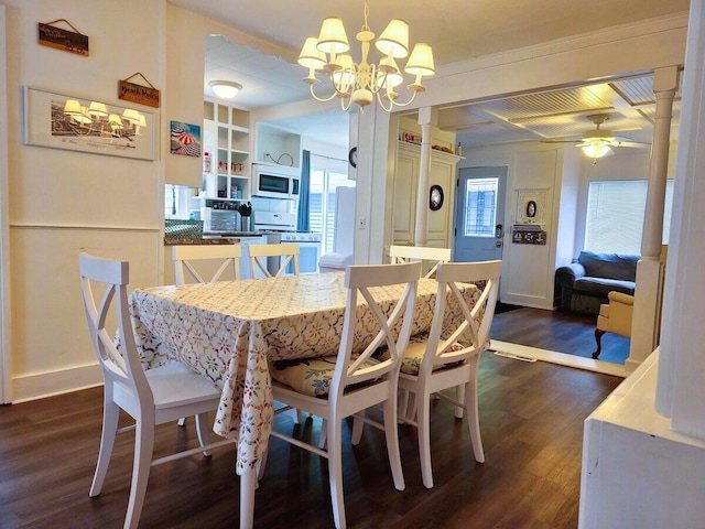 dining space with dark hardwood / wood-style flooring, ceiling fan with notable chandelier, built in features, and beamed ceiling