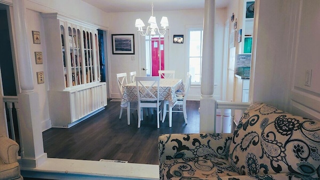 dining room featuring dark wood-type flooring and a chandelier