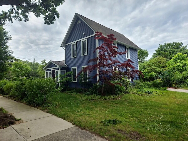 view of side of home featuring a lawn