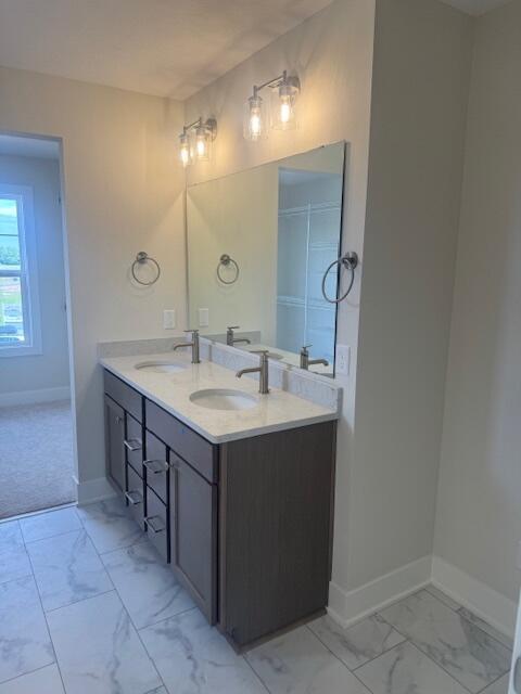 1967 Lowe Dr, Spring Lake, MI 49456 - bathroom featuring marble look tile flooring and double vanity