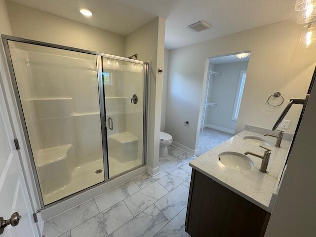 1967 Lowe Dr, Spring Lake, MI 49456 - full bathroom with marble finish floors, a shower stall, double vanity, and recessed lighting