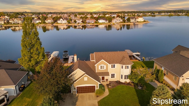 drone / aerial view with a water view and a residential view