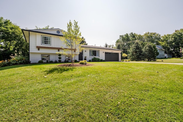 split level home with a garage, brick siding, driveway, and a front lawn