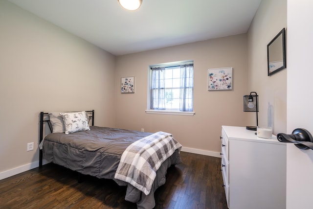 bedroom featuring dark wood-type flooring and baseboards