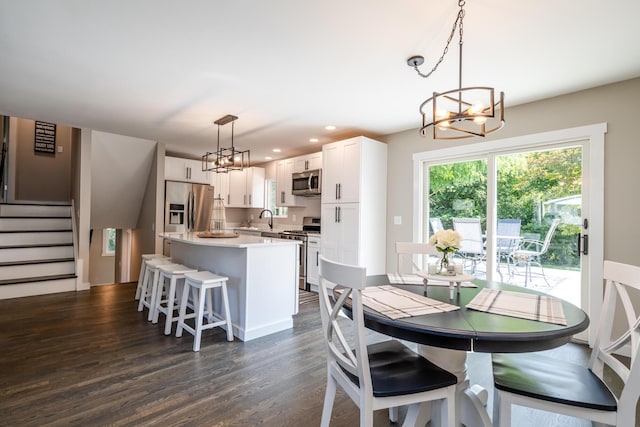 dining space featuring stairs, dark wood-style flooring, recessed lighting, and a notable chandelier