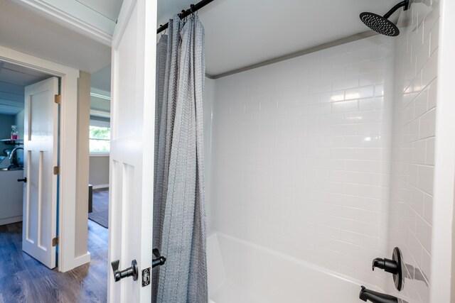 full bath with shower / tub combo and wood finished floors