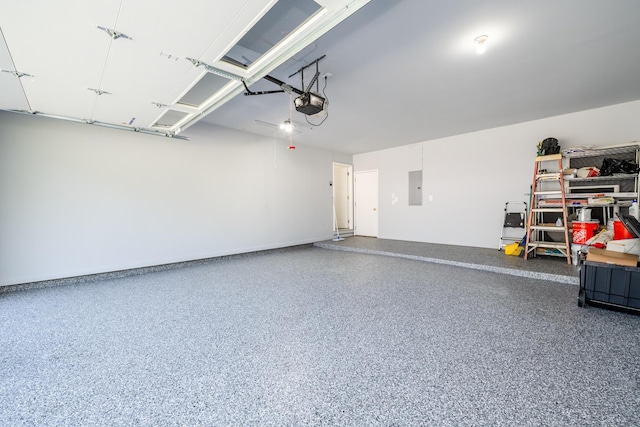 garage with electric panel and a garage door opener