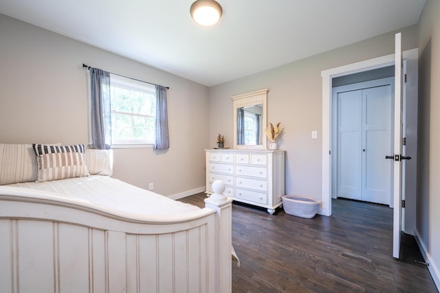 bedroom with multiple windows, baseboards, and dark wood finished floors