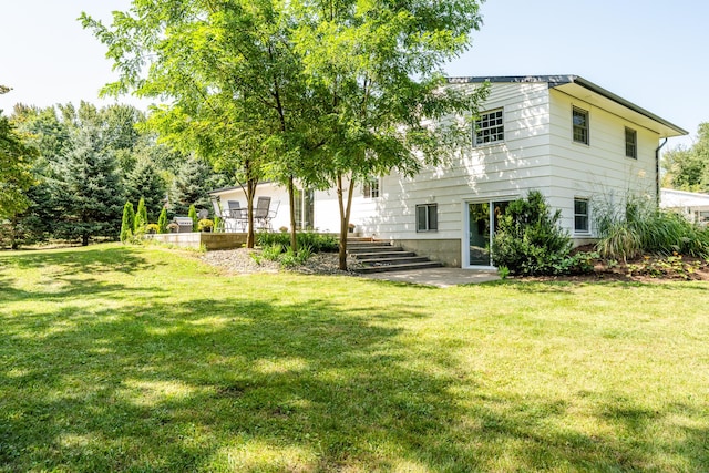 rear view of property featuring a yard