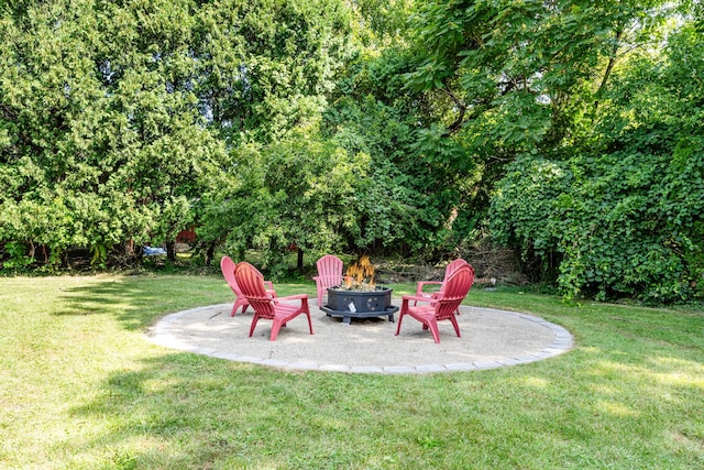 view of yard featuring a fire pit and a patio