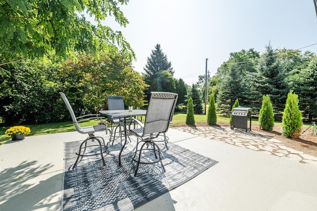 view of patio featuring outdoor dining area and a grill