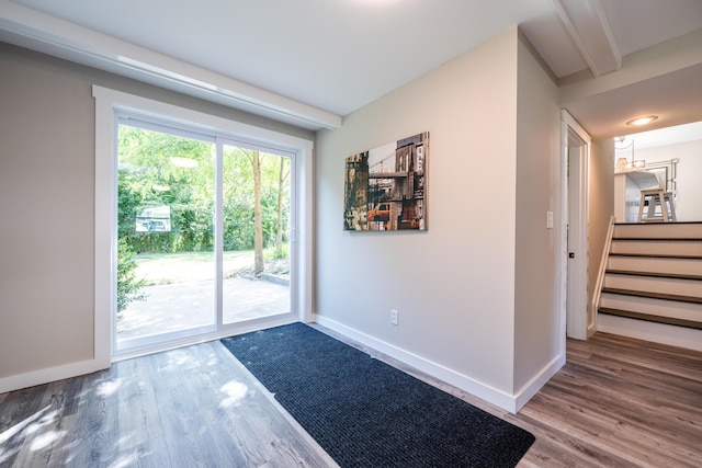 doorway to outside featuring stairway, baseboards, and wood finished floors