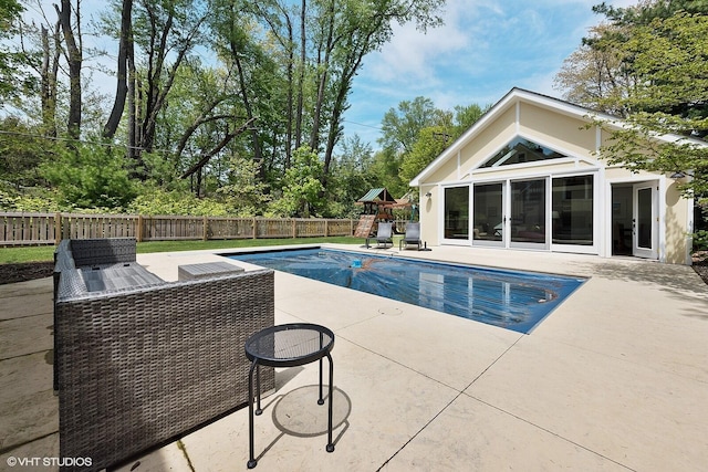 view of pool featuring an outbuilding, a fenced backyard, a fenced in pool, a patio area, and an exterior structure