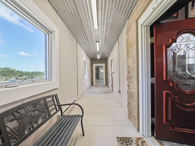 corridor with concrete flooring and concrete block wall