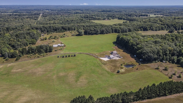 birds eye view of property featuring a forest view and a rural view