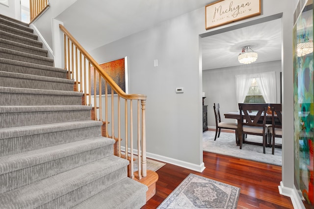 stairway featuring baseboards and wood finished floors