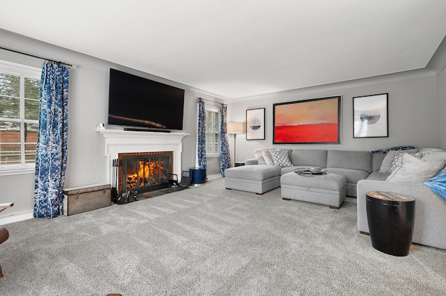 living room with carpet floors, a fireplace, and baseboards