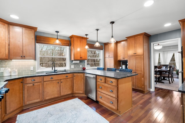 kitchen with dishwasher, dark wood-style flooring, a sink, and brown cabinetry