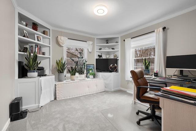 carpeted home office with baseboards, built in shelves, and ornamental molding