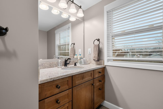 bathroom with vanity and baseboards