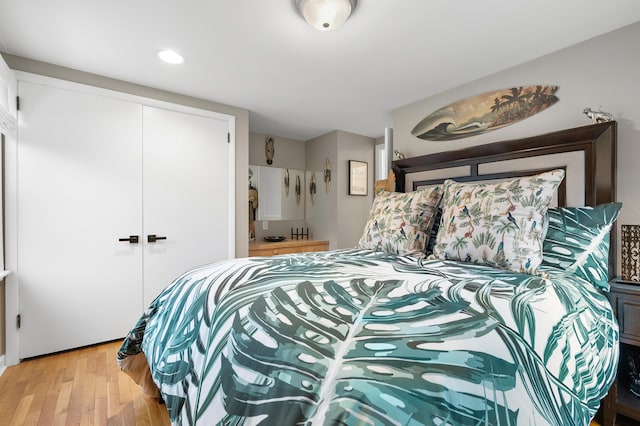 bedroom with light wood-style floors and a closet