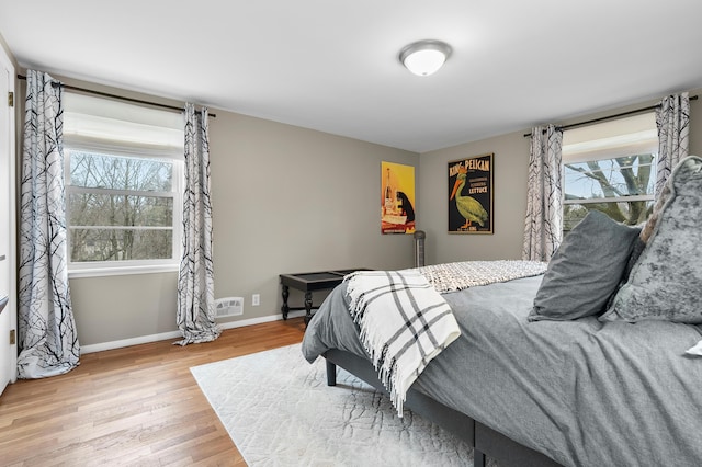 bedroom featuring baseboards and wood finished floors