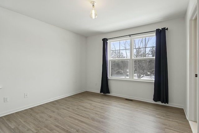 unfurnished room with light hardwood / wood-style flooring