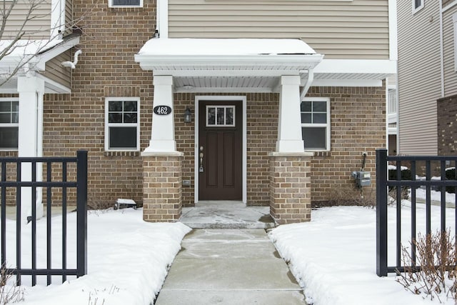 view of snow covered property entrance