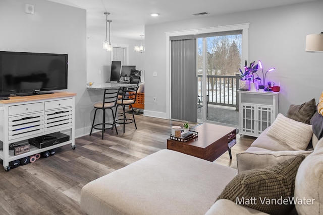 living room featuring baseboards, visible vents, dark wood finished floors, and recessed lighting