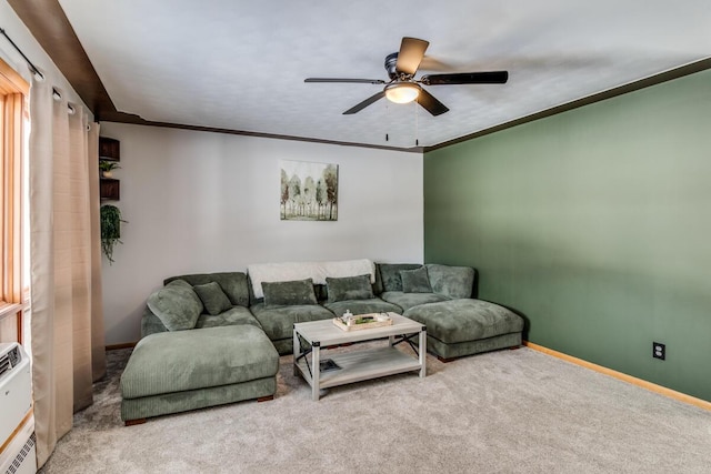 living room with carpet floors, ornamental molding, a ceiling fan, and baseboards