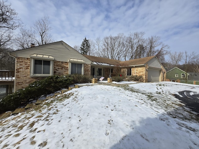 view of front of property featuring brick siding and an attached garage