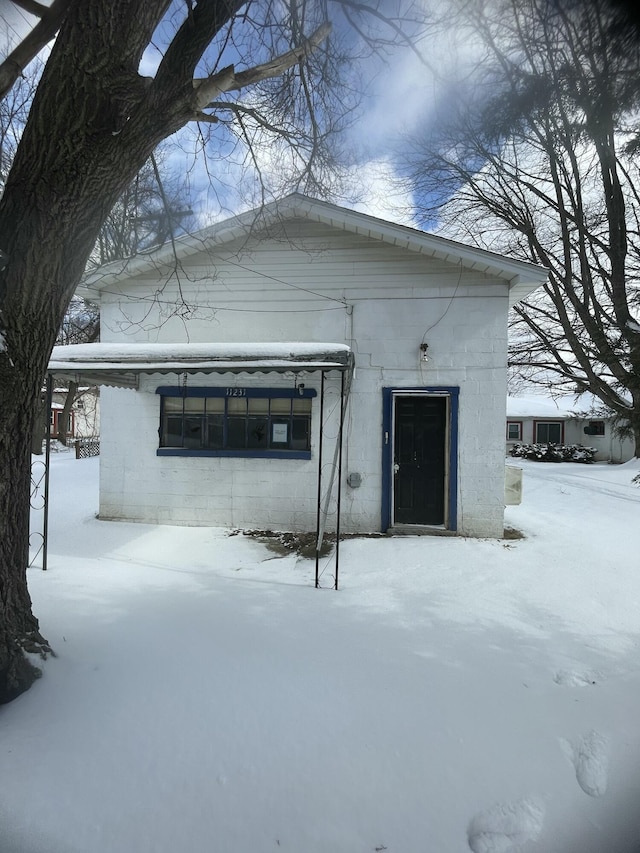 view of snow covered rear of property