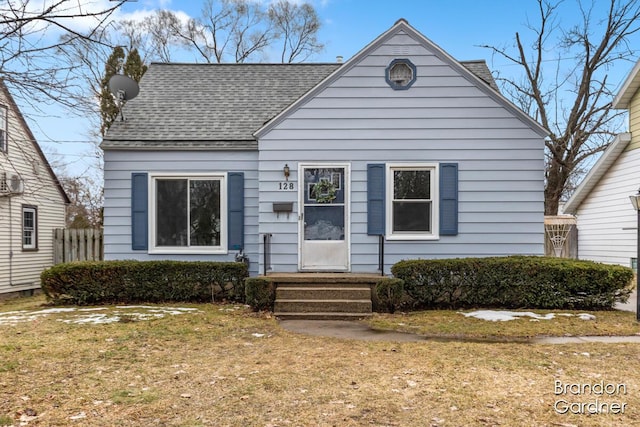 bungalow-style home featuring roof with shingles