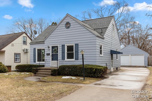 view of front of property with a garage, a shingled roof, and an outdoor structure