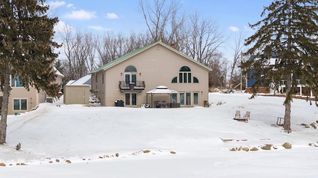 snow covered house featuring a gazebo