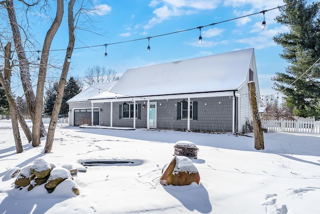 view of front of home with an attached garage and fence