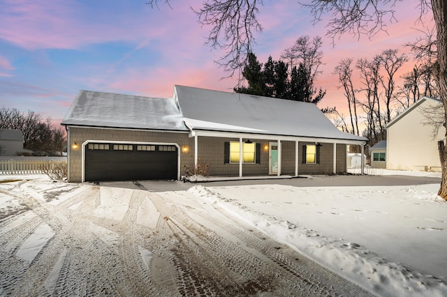 view of front of house with covered porch and an attached garage