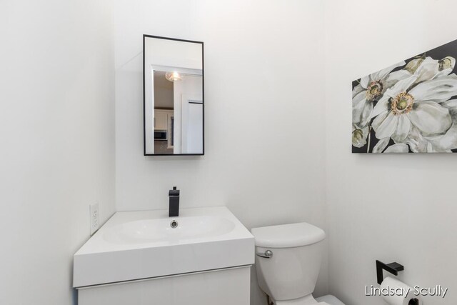bathroom with toilet and vanity