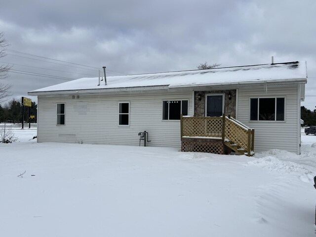 view of snow covered rear of property