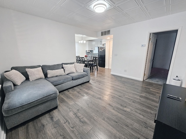 living room featuring a chandelier and wood-type flooring