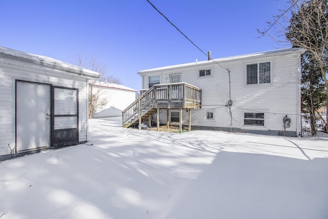 snow covered property featuring a wooden deck