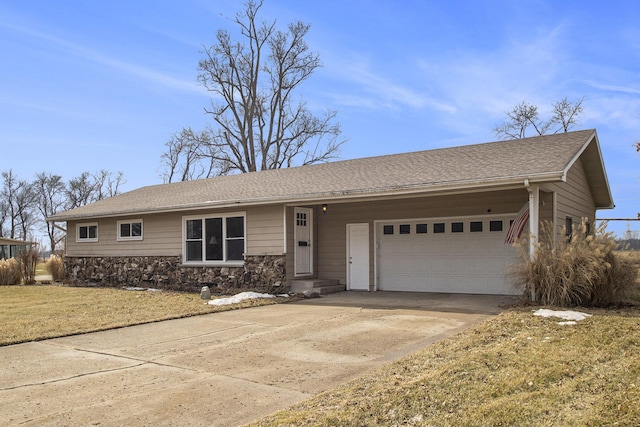 single story home featuring roof with shingles, a front yard, a garage, stone siding, and driveway