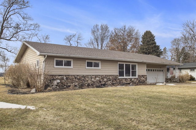 view of front of home with stone siding, a front lawn, an attached garage, and a shingled roof