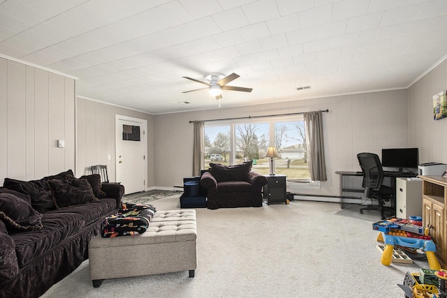 carpeted living room featuring a baseboard heating unit, ceiling fan, ornamental molding, and visible vents