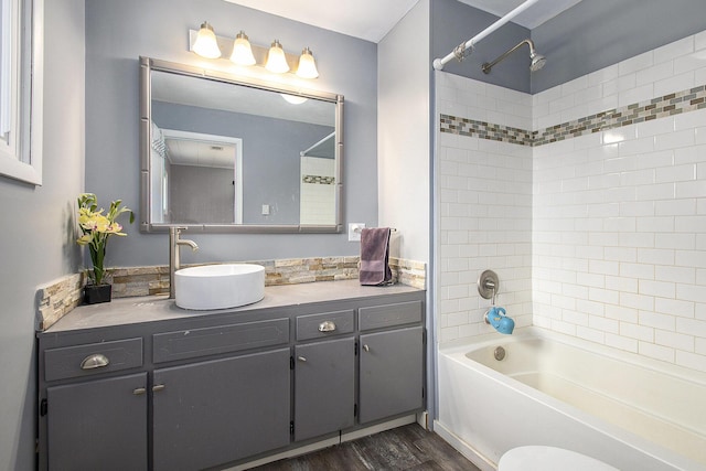 bathroom with shower / washtub combination, vanity, and wood finished floors